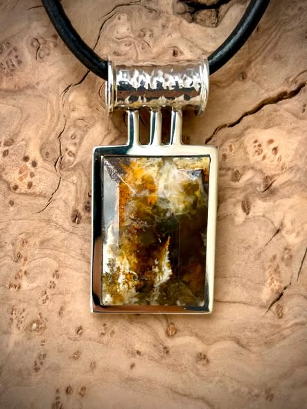 Graveyard Point plume agate pendant, faceted